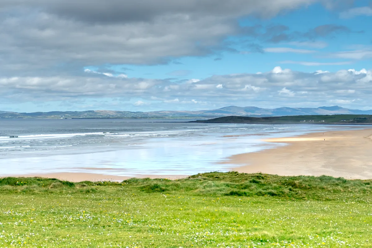Surf rolling into Tullan Strand beside Bundoran under a big Donegal sky