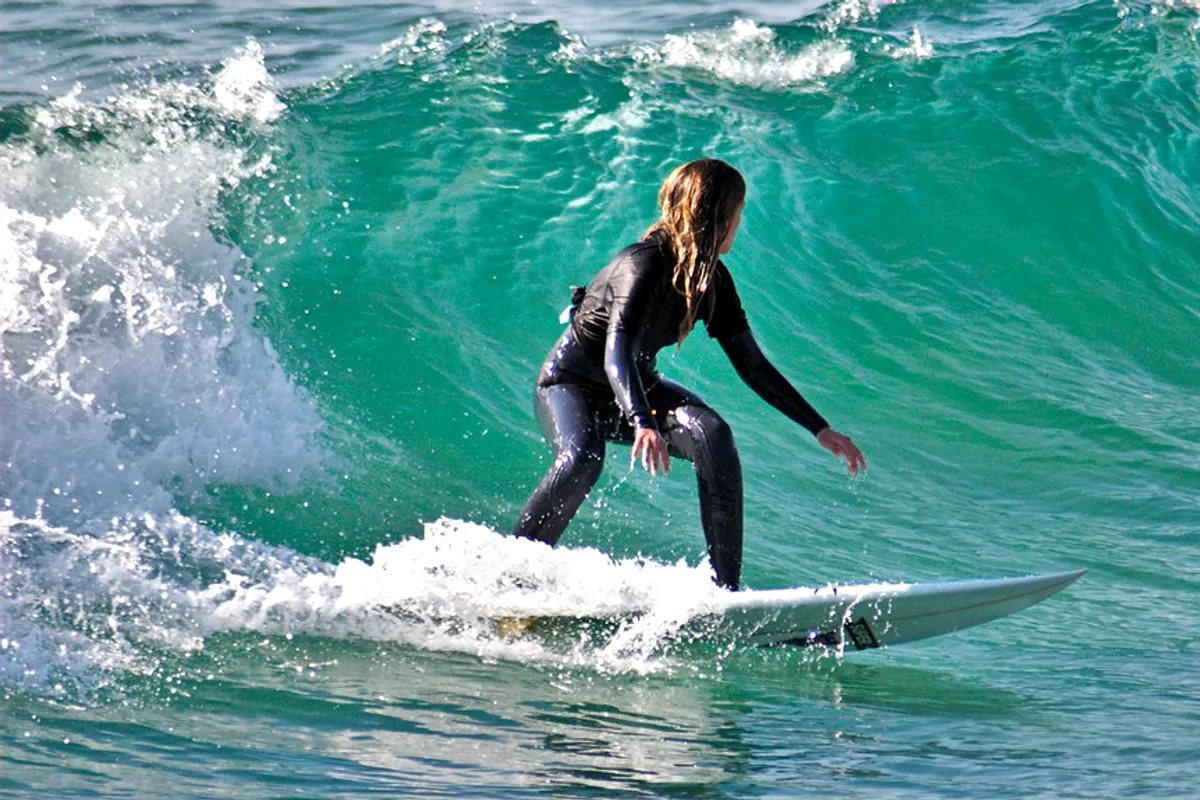 A surfer riding a green wave at Costa da Caparica