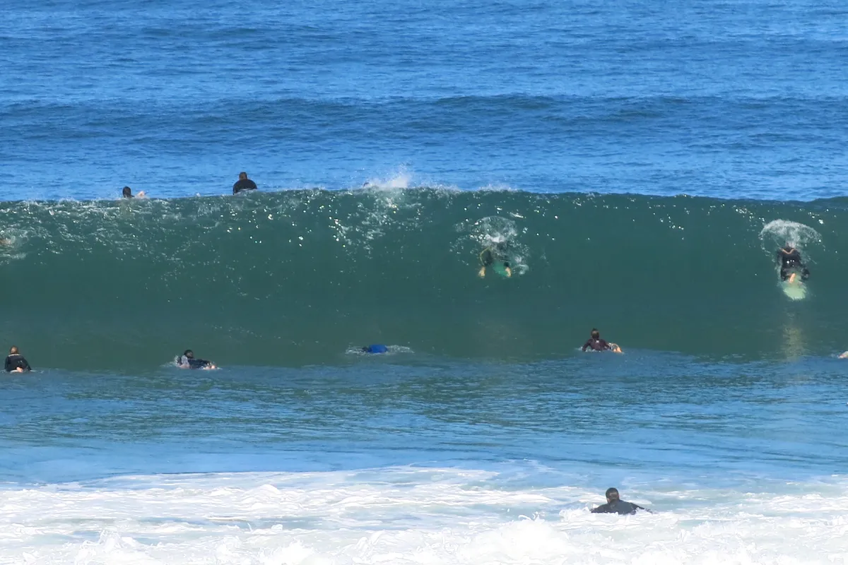 Surfers riding waves at Capbreton on the Landes coast of France