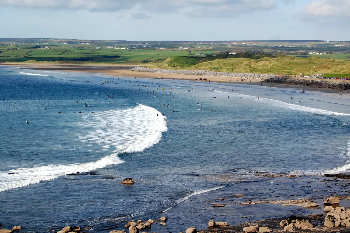 Surfers in the water at Lahinch Strand, County Clare