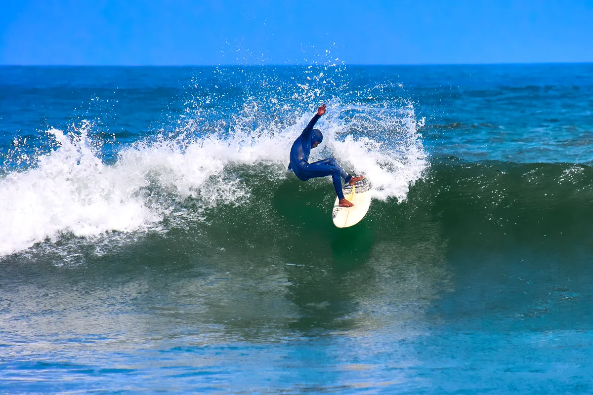 A surfer carving across a wave in Peru