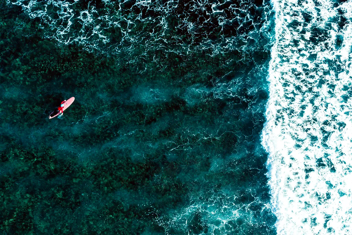 A surfer catching a wave at Cloud 9, Siargao Island