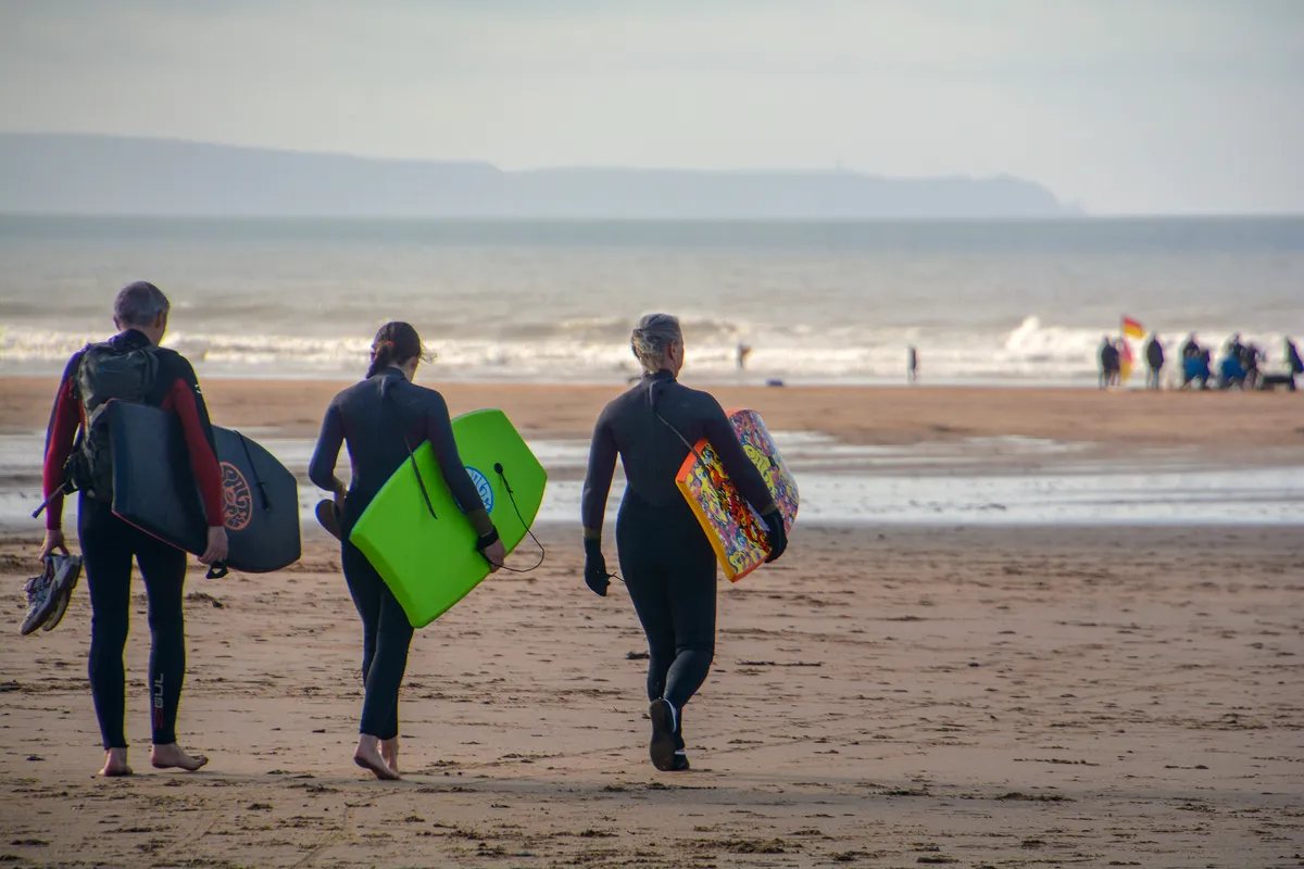 Surfers and bodyboarders on Croyde Sand in North Devon