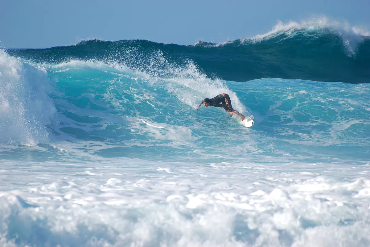 A surfer on a wave at the Banzai Pipeline, North Shore of Oahu