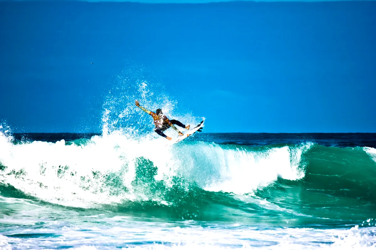 A surfer launching off the lip at the Quiksilver Pro France in Hossegor