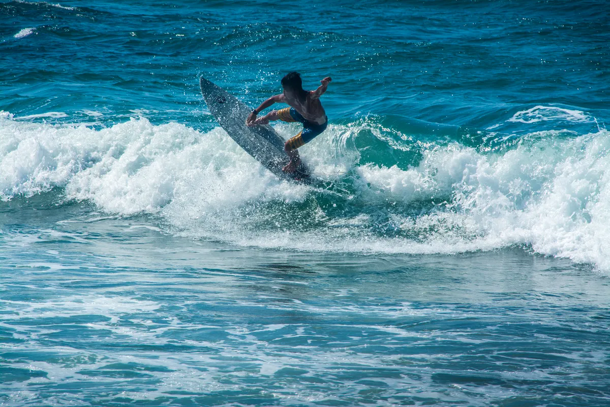 A surfer riding a wave in La Union, the surfing capital of northern Luzon