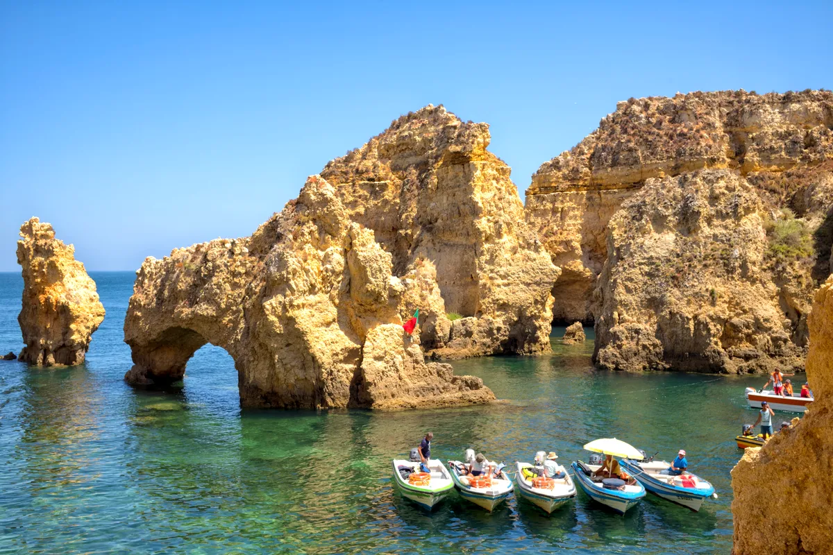 Boats among the golden rock arches of Ponta da Piedade, Lagos