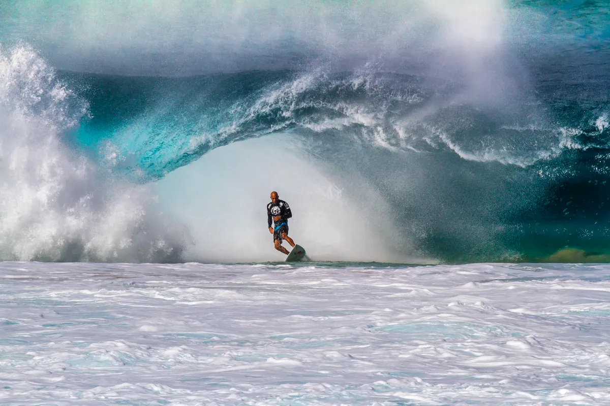 A rider escaping a heavy wave at the Banzai Pipeline, North Shore