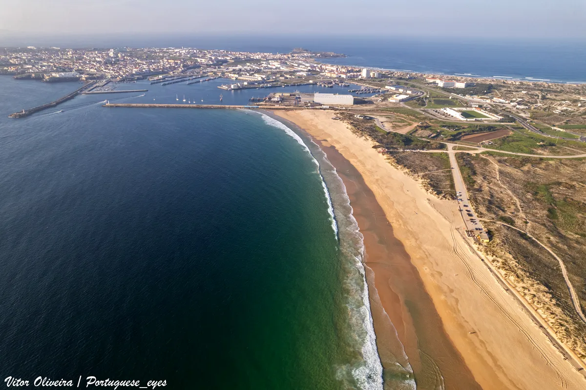Aerial view of Praia dos Supertubos curving towards Peniche