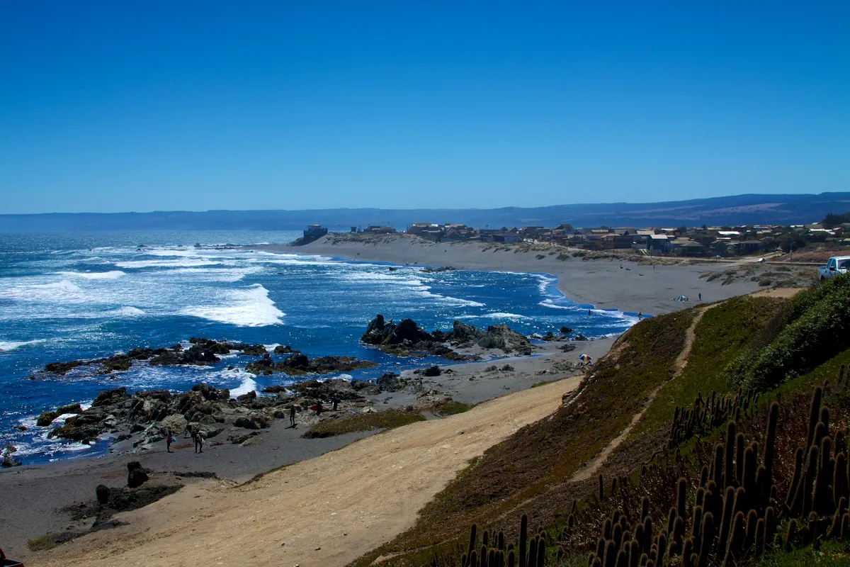 Waves breaking on the rocks and beach at Playa la Caletilla, Pichilemu