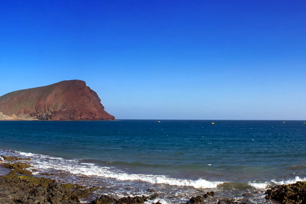 Montaña Roja rising behind La Tejita beach near El Médano, Tenerife